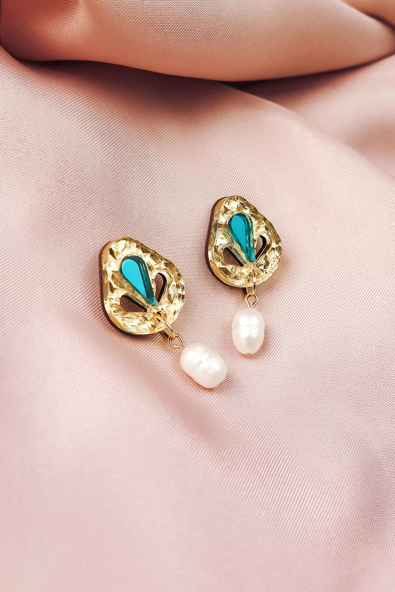 Handcrafted gold Basic Drop Earrings with turquoise teardrop accents and dangling white pearls, displayed on a soft, light pink satin fabric—perfect for adding subtle elegance to your minimalist fashion collection.