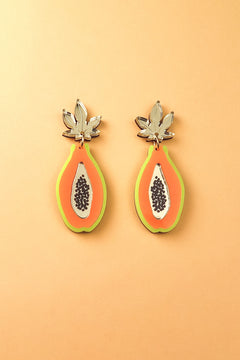 Papaya Earrings made of allergy-free stainless steel and neon acrylic glass, featuring orange with green edges, black seed details, and silver leaves, all set against a peach-colored background.