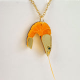 A whimsical gold Shrimp Pendant Necklace featuring a realistic orange and beige shrimp, displayed against a plain white background for a playful touch.