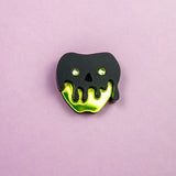 A pin shaped like an apple with a shiny yellow bottom and a black, drippy skull design on top, this Poisoned Apple Badge is perfect for Halloween lovers. Set against a plain light purple background—grab yours now, as stock is limited!.
